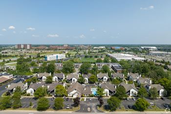 A bird's eye view of a residential area with houses and a parking lot
